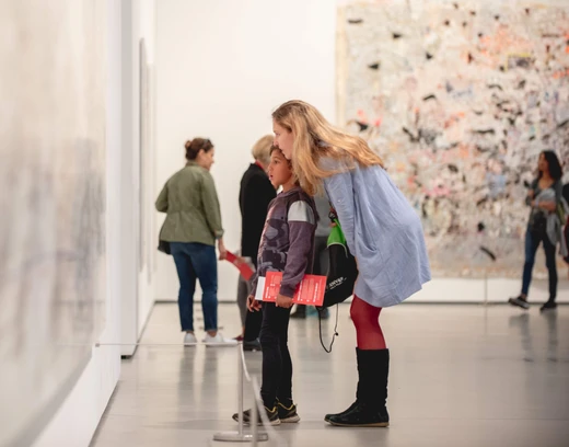 Photo of a woman and a boy looking at a painting at The Broad together